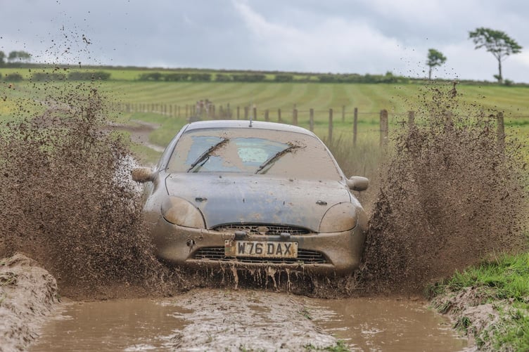 Playing dirty John Tyres Davies and Eurig Davies make a splash in the mud hole in the Ford Puma en route to victory