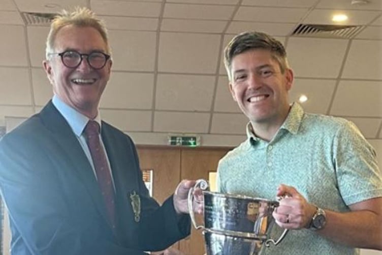 Men's captain Hil Brunner presents the Wright Cup to Jack Shelley