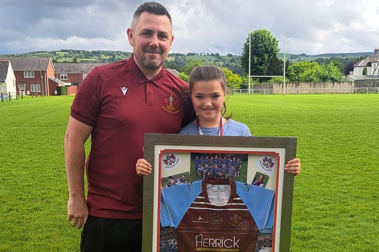 Manon Gruffudd was presented with a memento of her time with Lampeter's mini and junior teams by under 11s coach and club secretary Gareth Davies