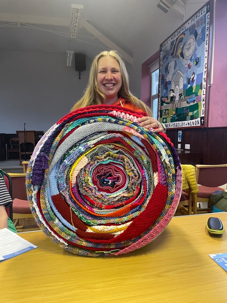 Keira Davies with a roll of scarves. Photo: Keira Davies