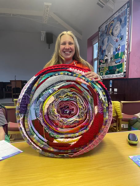 Keira Davies with a roll of scarves. Photo: Keira Davies