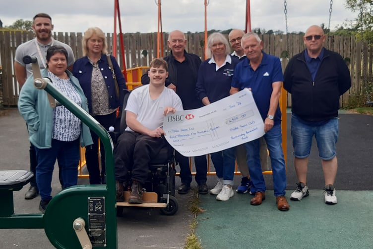 Left to right: Mr Brunelli, Gwen Evans (Jammy Dodger), Jackie Thomas (Jammy Dodger), Nigel Beattie, Lynne Gilbertson, Jerry Gilbertson (men's captain MYC Rowing), Mike Morris and Rob Murray presenting the cheque to pupil Lewis Walker (centre)