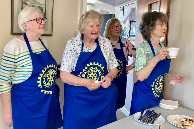 Inner Wheel members in their blue aprons enjoy a break at the Strawberry Tea