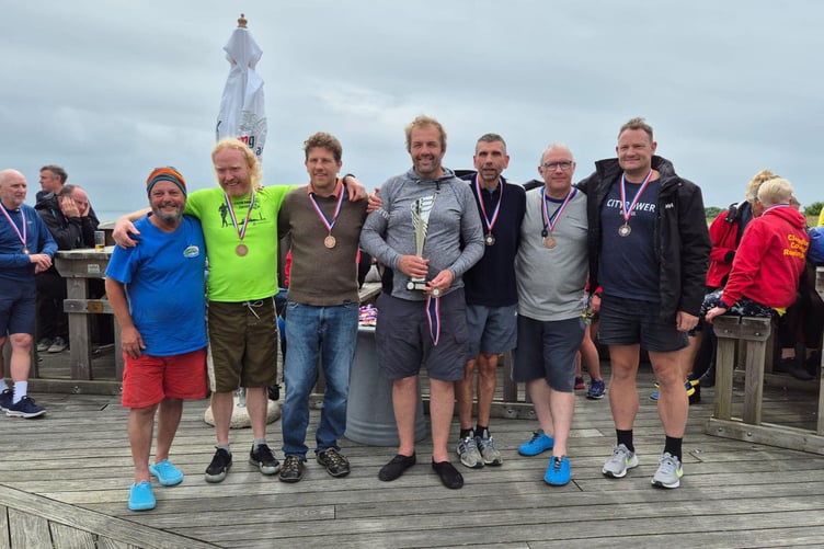 Aberystwyth pose with the veteran's class trophy after completing the Cardigan Bay Challenge. L-R, Neil Smith, Sam Clemmens, Seb Mcbride, Bleddyn Jones, Mel Hopkins, Ian Kavanagh, Dan Bohin (Photo: Louise Russell)