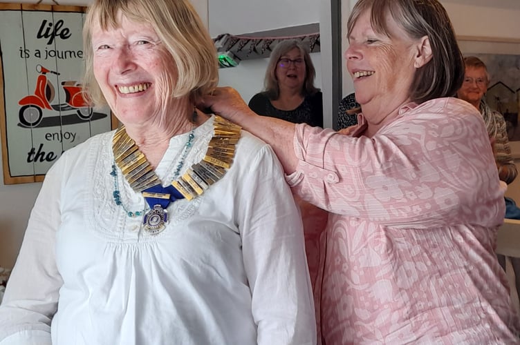 Outgoing president Siân Bell hands over the chain of office to the incoming president Lynda Morris