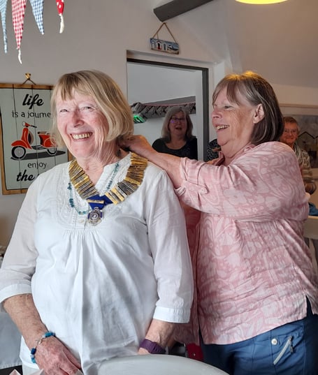 Outgoing president Siân Bell hands over the chain of office to the incoming president Lynda Morris
