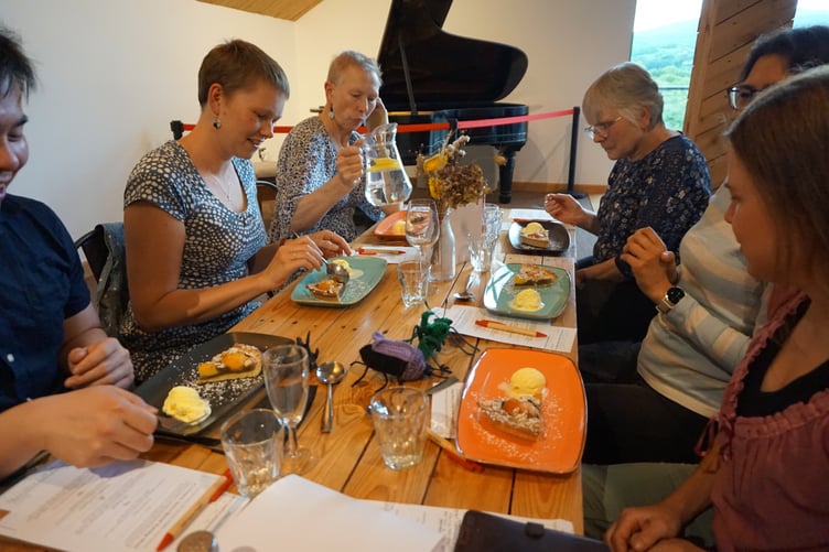 One of the tables tucking into James and the Giant Peach tart - an Italian tart with poached peaches, nutty almond and cricket flour frangipane and clotted cream ice cream