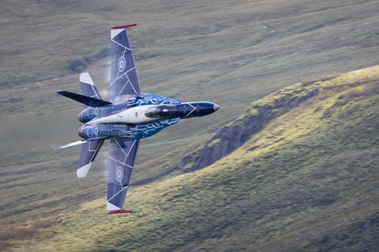 The Royal Canadian Air Force's (RCAF) CF-18 Hornet flies through the so-called Mach Loop in Wales, July 17 2024. Jaw-dropping images show a warplane zooming through Wale's so-called Mach Loop on Wednesday (17 July). The Royal Canadian Air Force's (RCAF) CF-18 Hornet showed off its agility while it made its way to RAF Fairford as it prepares to display at the 2024 Royal International Air Tattoo. The pilot showing off his skills is Captain Caleb âTangoâ Robert, who serves as a combat-qualified element lead on the CF-18 for 425 (Alouettes) Tactical Fighter Squadron at 3 Wing in Quebec. The Mach Loop is a series of valleys in west-central Wales, notable for their use as low-level training areas for fast aircraft. The Loop is among the few places in the world where photographers can see combat aircraft flying below them.