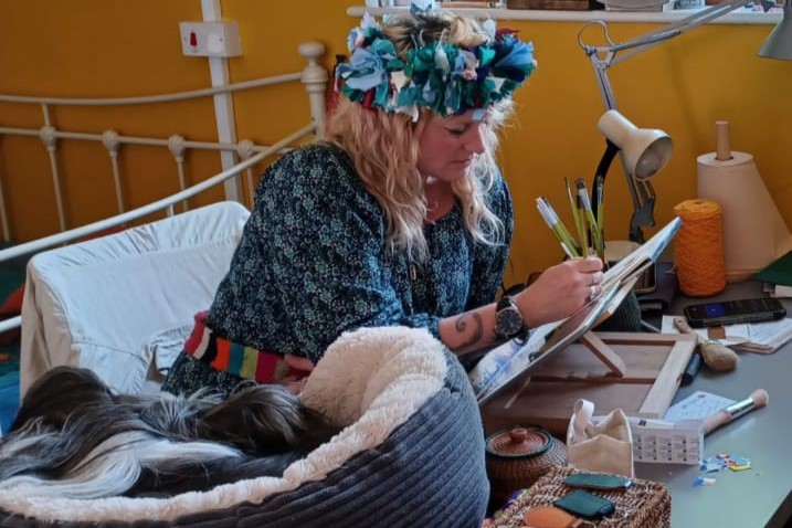 Enfys in her studio with her dog