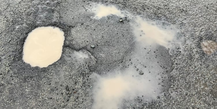 Budget underspend should be used to fix potholes in Powys, a councillor has said