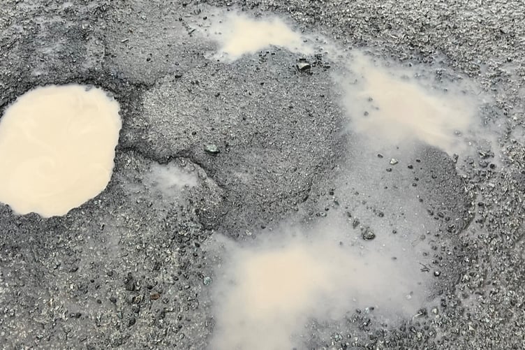 Budget underspend should be used to fix potholes in Powys, a councillor has said
