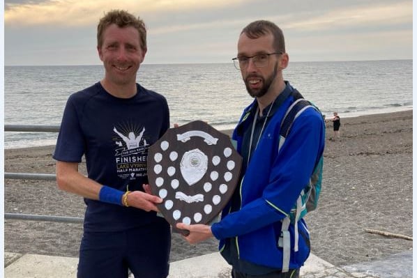 Owain Schiavone receiving his trophy from Ian Evans