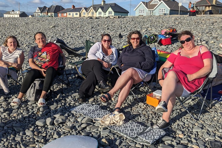 Coaches, assistants and committee members enjoy the sun at Borth