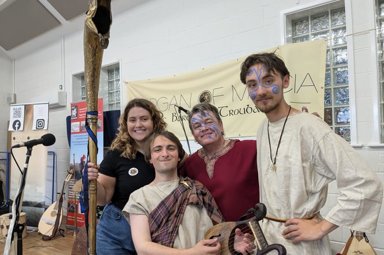 Morgan of Mercia and troubadours with Beca Davies holding the Carnyx war horn. Photo: Crown Copyright: RCAHMW