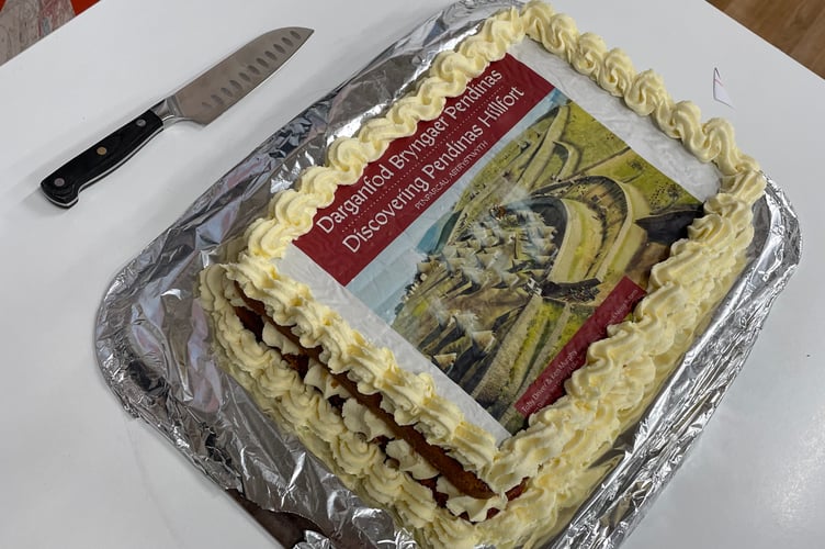 Celebratory cake topped with book cover image Photo: Crown Copyright: RCAHMW