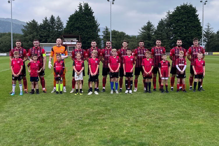 Port Under 10s line up with the seniors before the game against Holyhead Hotspur at the Traeth on Saturday