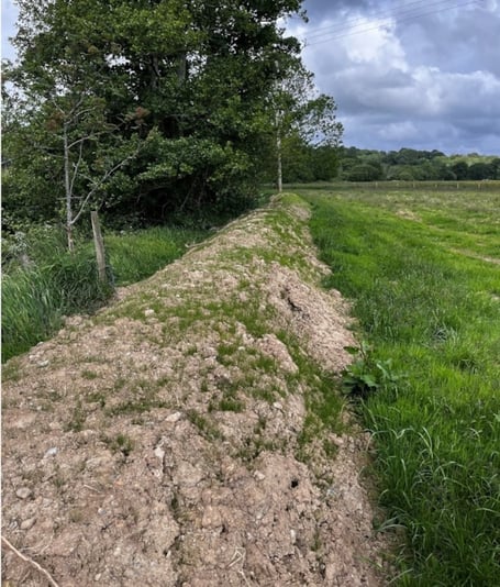 The earth bund before remediation work took place. Photo: Natural Resources Wales