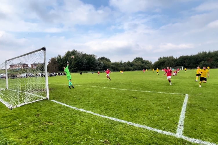 Tom Hilditch chips in Porthmadog's first goal against FC Queens Park