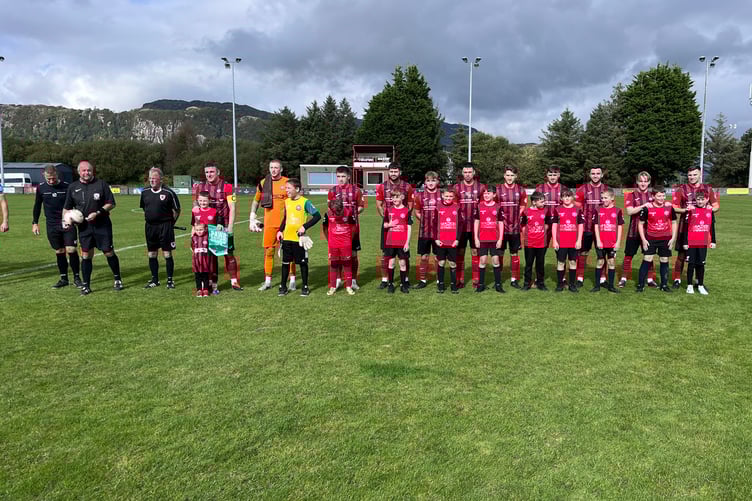 Porthmadog under 12s line up with the senior players before kick off after winning their first game of the season 5-2 against Nefyn in the morning