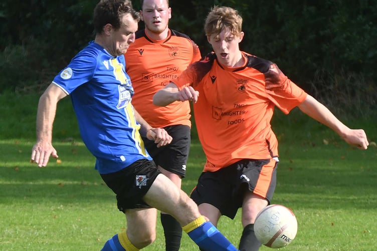 Tywyn Bryncrug's Max Andrews (right) battles for possession (Photo: Doris O'Keefe)