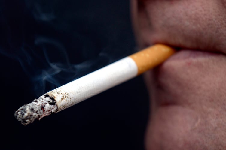 PICTURE POSED MY MODEL: A general view of a man smoking a cigarette.