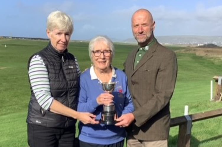 Nans Morgan (middle) presenting Catrin Pugh Jones and Alan Shaw with the trophy