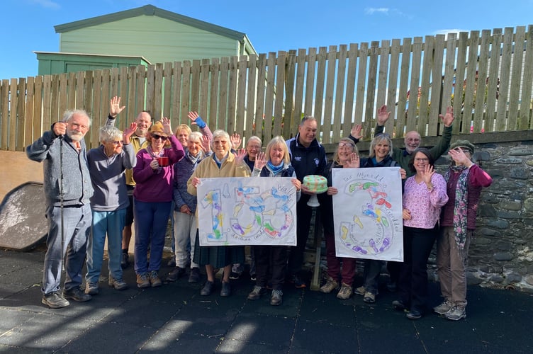 Members of the walking group marked three years with cake