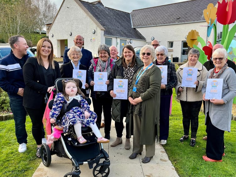 Llyn Peninsula Friends of Ty Gobaith group (with certificates) and the Hughes family whose daughter Matilda (front) attends the hospice in Conwy