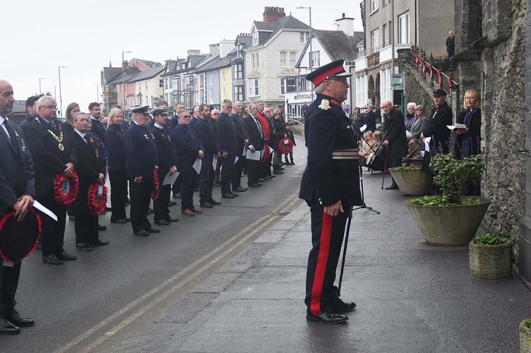 Lord Lieutenant of Gwynedd Edmund Bailey pays his respects at Aberdyfi's War memorial after laying the first wreath on behalf of the King. Photo: Doris O’Keefe