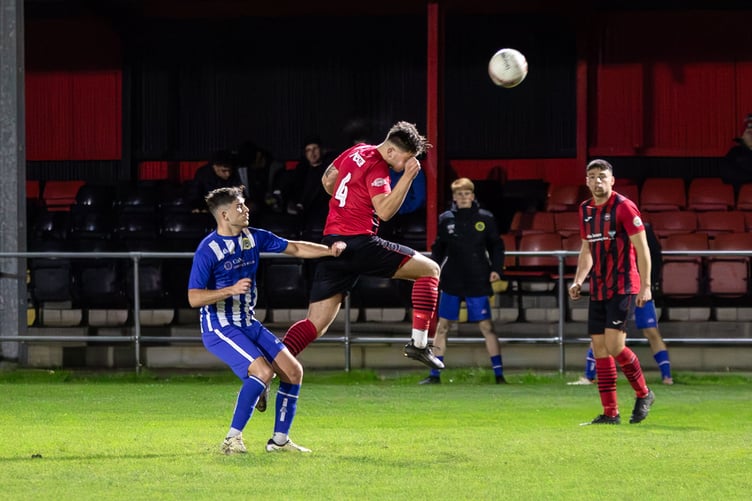 Porthmadog's Gruffydd Eliis gets his head to the ball (Photo: Jeff Guile)