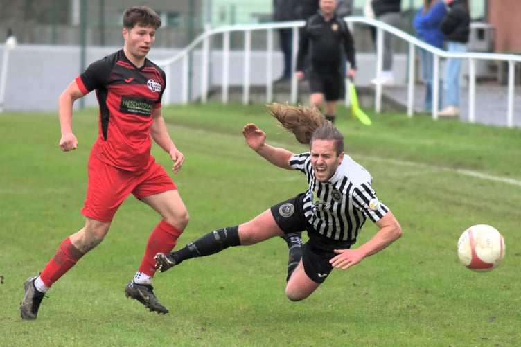 Bow Street's Iolo ap Dafydd takes a tumble during the 2-2 draw against Llanfair United (Photo: Bev Hemmings)