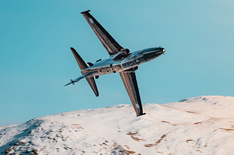 Hawk T2 advanced trainer aircraft flies through Mach Loop in Eryri National Park (Snowdonia) on November 21, 2024. Jaw-dropping pictures show RAF airplanes zooming through a snowy Mach Loop in Wales on Thursday (21 Nov). An RAF Hawk T2 advanced trainer aircraft and an A400M transport aircraft were caught on camera by Sgt 'Matty' Matthews. The 84-ton A400M had already completed an airdrop over Salisbury Plains, flown over Scotland and the Lake District before passing through the Mach Loop and heading home to RAF Brize Norton in Oxfordshire. "Come rain or snow, RAF aircraft and their crews continue to operate whatever the weather," said the RAF, "In this case, with the snowy backdrop of the Eryri National Park behind them."