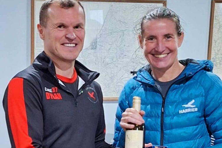 Louise Barker receiving her age category trophy at Ras y mast from Sarn Helen chair, Dylan Wyn