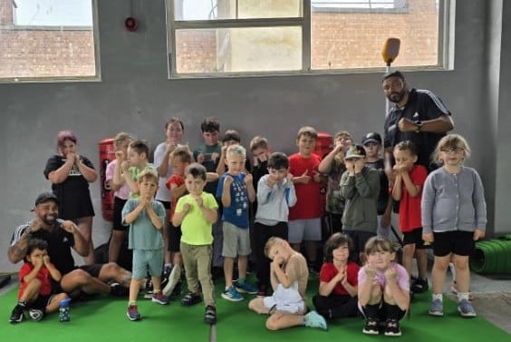 Jamie Ambler and Jason Spencer with their students at Jay Jay's Amateur Boxing Club