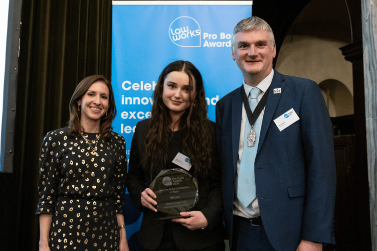 Veterans Legal Link case worker Megan Perrins (centre) accepting the award on behalf of the team at the award ceremony in London on 4 December 2024, with event host and political commentator Tamara Cohen and Vice President of the Law Society of England and Wales, Mark Evans
