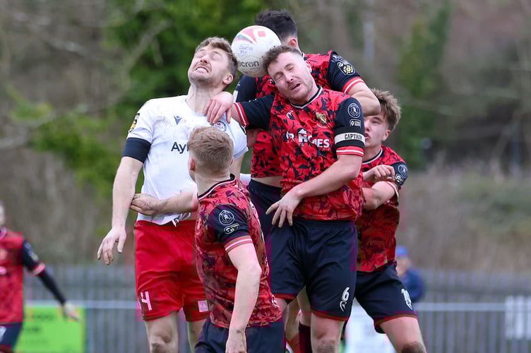 Cardiff , WALES - 14 DECEMBER 2024: Thomas Mclean of Caerau Ely FC challenges for the aerial ball with Nathan Peate of Bala Town FC during the 2024/25 FAW Welsh Cup fixture between Caerau Ely FC & Bala Town FC at Cwrt-Yr-Ala, Cardiff, Wales. (Pic by Geraint Nicholas/FAW)