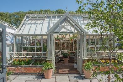 The use of partitions in Greenhouses is becoming increasingly popular as gardeners look for more precise control over their growing environment and formally divide structures for additional lifestyle uses.