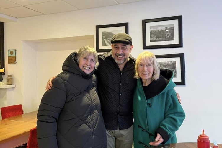 Ahmet Acikel with two visitors to his cafe on Christmas Day this year