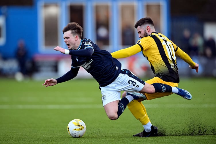 HAVERFORDWEST, WALES - 01 JANUARY 2025: Haverfordwest County's Rhys Abbruzzese is fouled by Aberystwyth Town's John Owen during the JD Cymru Premier 24/25 Phase 1 match between Haverfordwest County A.F.C and Aberystwyth Town F.C. at Bridge Meadow Stadium in Haverfordwest on the 1st January 2025. (Pic by Ashley Crowden/FAW)