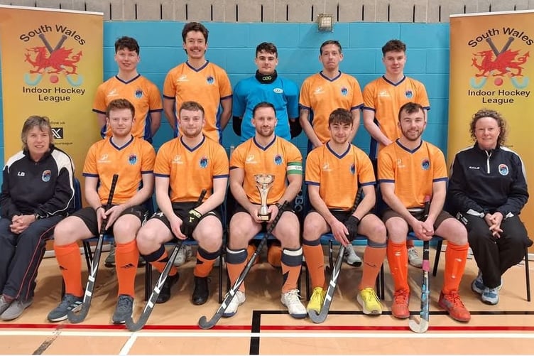 Back row left to right: Harry Bennett, Ed Iffla, Iwan Williams, Ryan Goddard, John Bennett. Front row left to right: coach Lynda Bennett, Conor O’Regan, Aodhan O’Regan, Rhys Hughes, Dafydd Jones, Gerallt Jones, manager Sue Williams (Photo: SW Indoor League Facebook page)