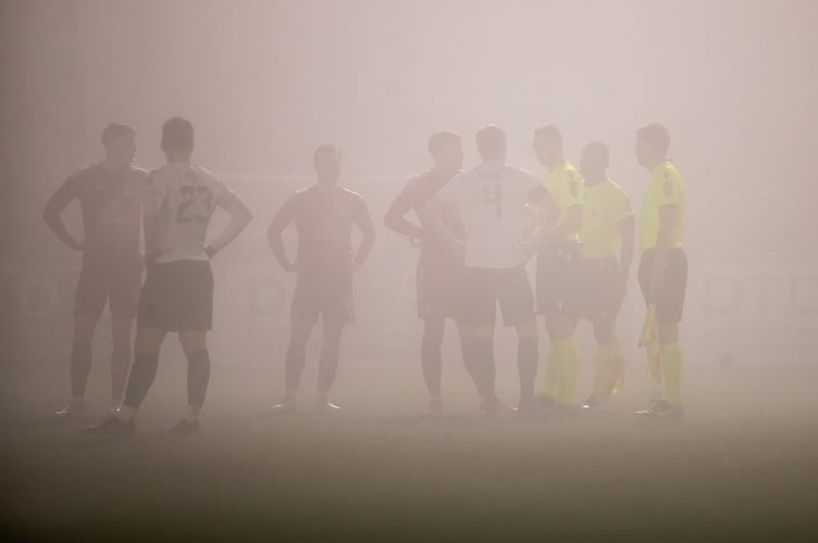 FLINT, WALES - 14TH JANUARY 2025: Match Officials talks to players as the conditions worsen during the JD Cymru Premier fixture between Connah's Quay Nomads and Bala Town at the Essity Stadium, Flint. 14th of January, Flint, Wales (Pic by Nik Mesney/FAW)