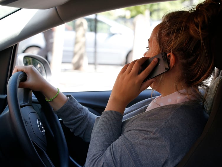 PICTURE POSED BY MODEL
A woman talking on her phone whilst driving.