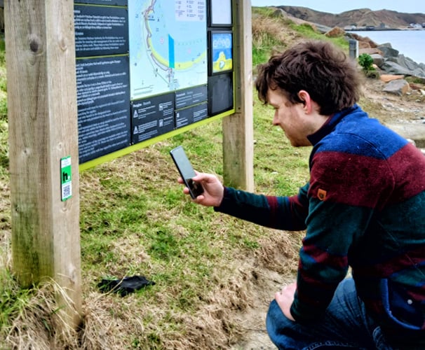 Scanning the HistoryPoints seagrass QR code at Morfa Nefyn