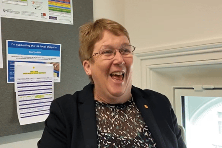 Ann Davies laughing to herself between takes from her new Westminster office