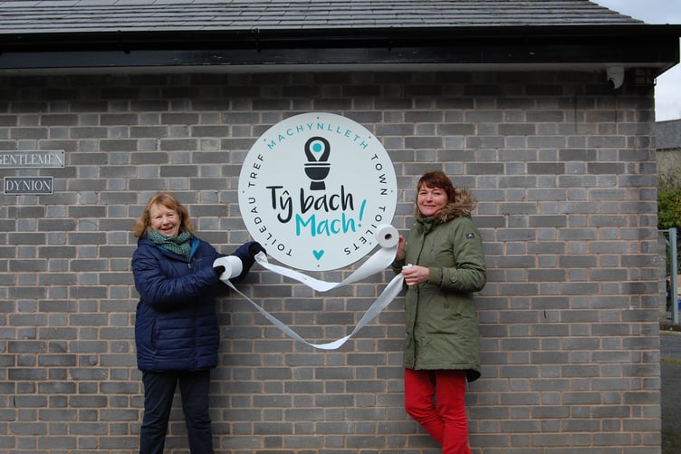 Councillors Norma McCarten (left) and Kim Bryan (right) at the reopening of the Machynlleth public toilets - renamed Ty bach Mach