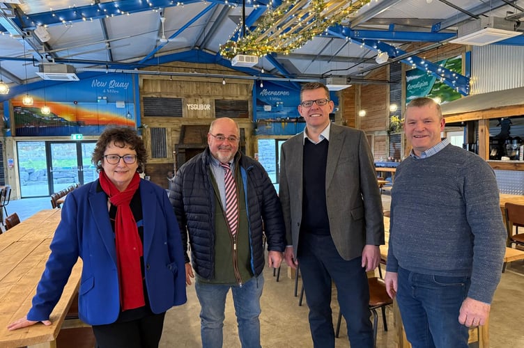 Elin Jones MS, Geraint Thomas, owner of the Moody Cow business, Rhun ap Iorwerth MS and Councillor Bryan Davies, Councillor for Llanarth Ward and Leader of Ceredigion County Council in the Moody Cow’s events room the Ysgubor