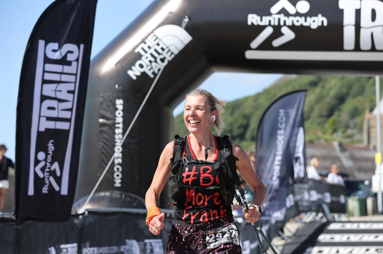 Lesley completing a race in her #BeMoreFrank vest