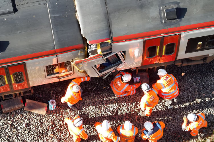 Teams work to separate the damaged trains on the Cambrian Line