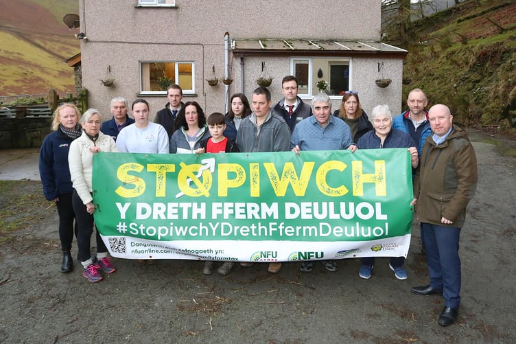 Three generations of the Jones family pictured with Plaid Cymru’s Liz Saville-Roberts MP, Mabon ap Gwynfor MS, NFU Cymru representatives and local businesses outside Ty’n y Braich