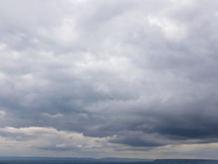 Partly cloudy with a chance of drizzle today and patchy rain tomorrow
